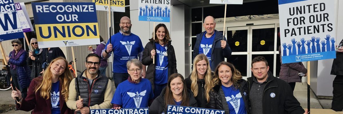 Striking hospital workers with signs.