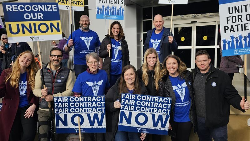 Striking hospital workers with signs.