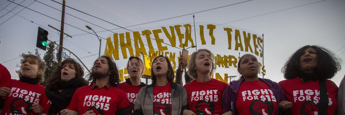 Striking McDonald's restaurant employees lock arms in an intersection before being arrested, after walking off the job to demand to demand a $15 per hour wage and union rights during nationwide 'Fight for $15 Day of Disruption' protests on November 29, 2016 in Los Angeles. (Photo: David McNew/Getty Images)