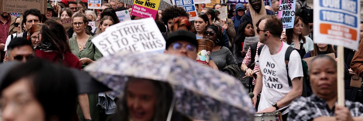 Striking NHS workers march from St Thomas' Hospital to Trafalgar Square in London on May 1, 2023.