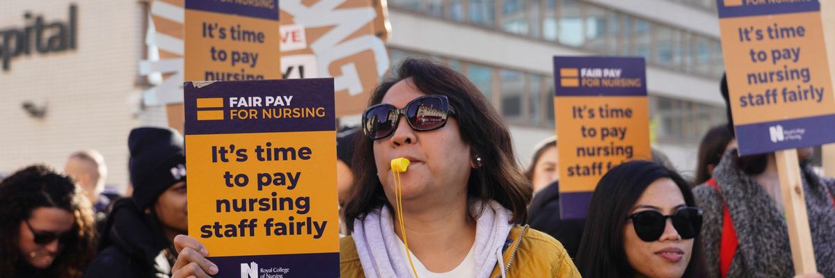 Striking nurses stand on a picket line outside St. Thomas' Hospital