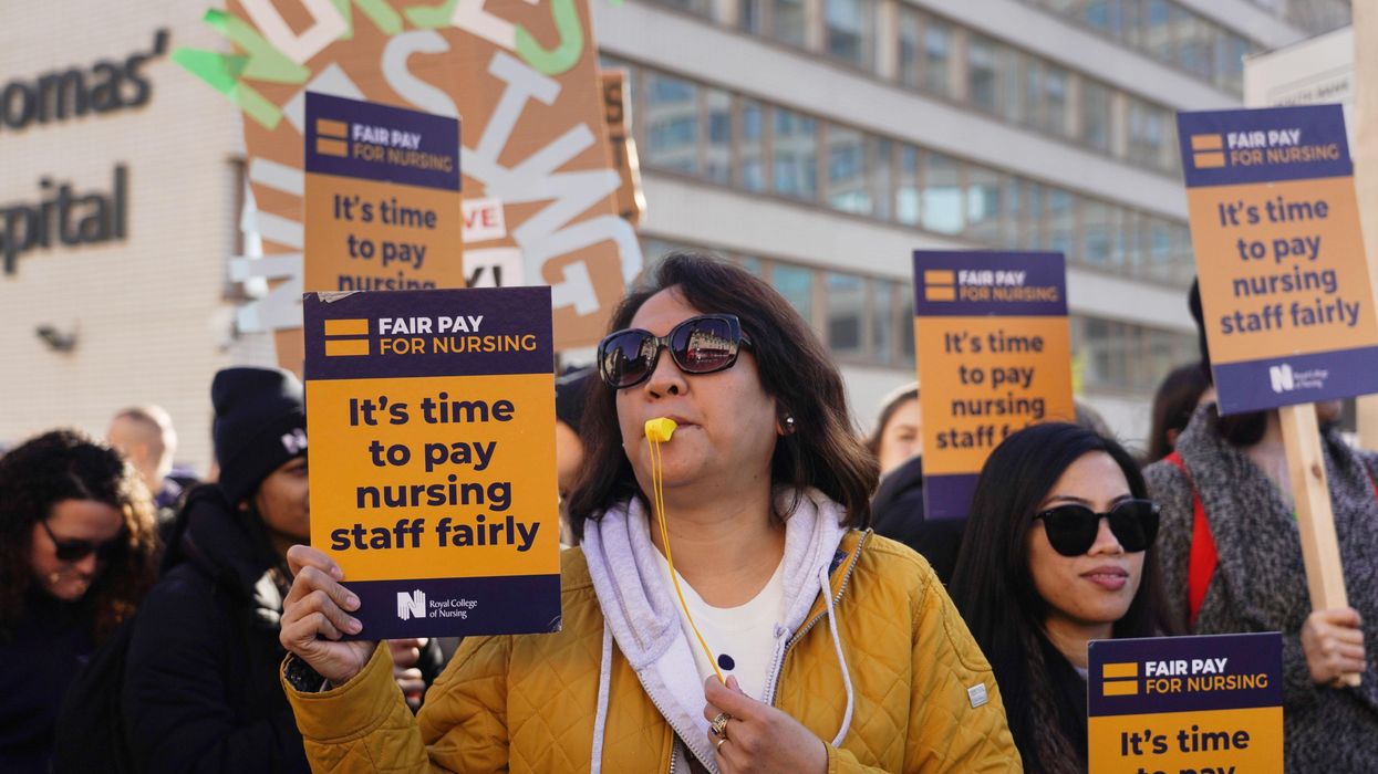 Striking nurses stand on a picket line outside St. Thomas' Hospital