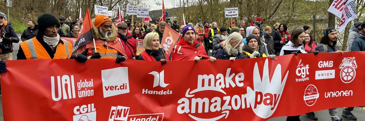 Striking workers hold a banner.