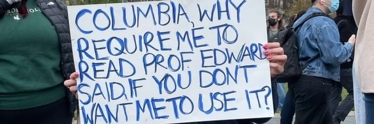 Student at Columbia holding sign reading, "Columbia, why require me to read Prof. Edward Said, if You don't want me to use it?"