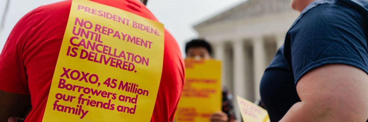 Student Debt relief advocates stand outside of the Supreme Court.
