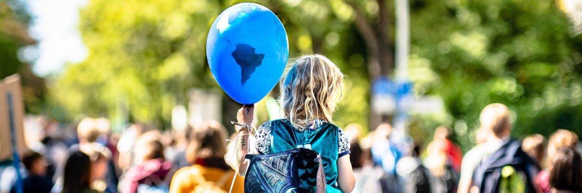 Student holding Earth balloon during demonstration