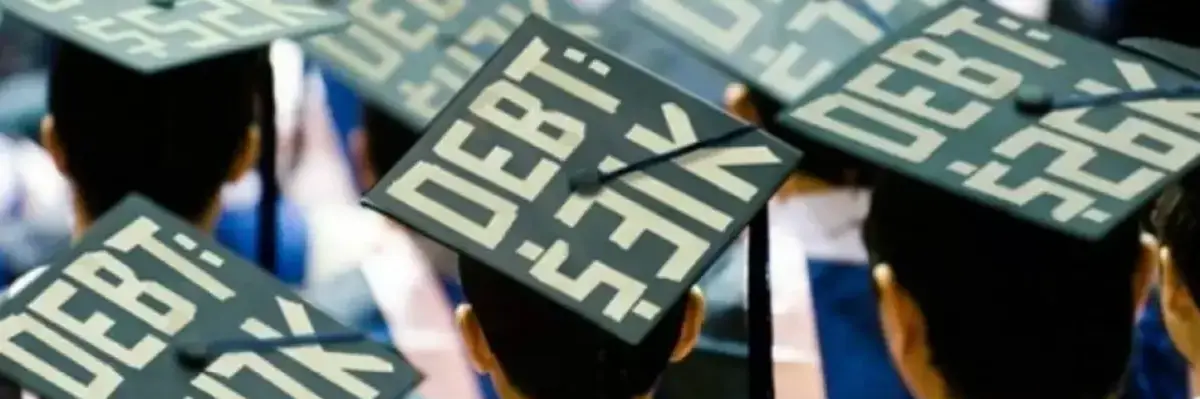 Students attend a graduation with the amount of money they owe in student loans on their caps.