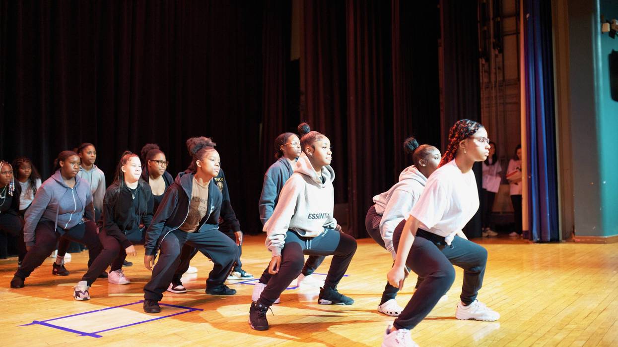 Students dancing on a stage.