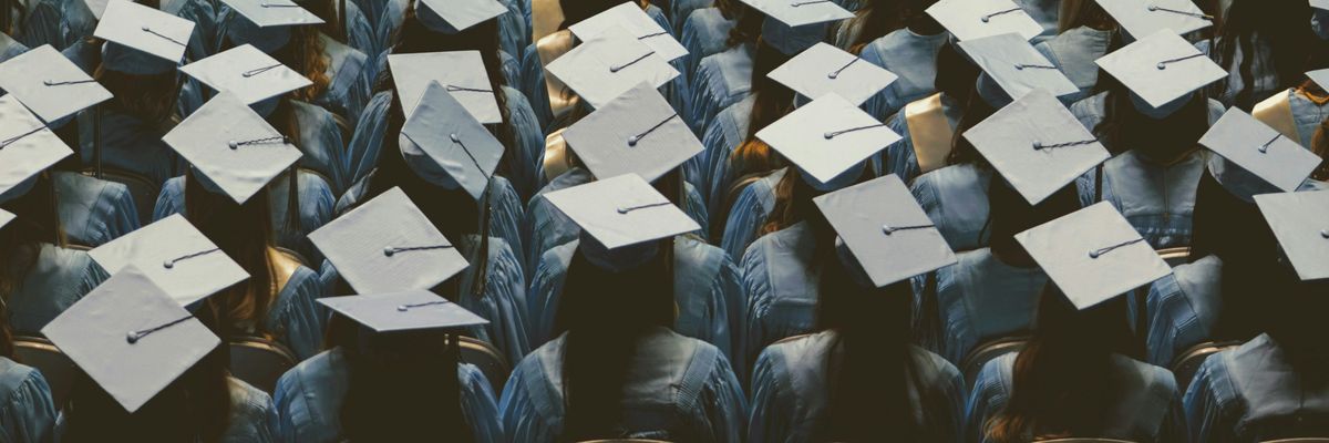 Students in rows in graduation hats.