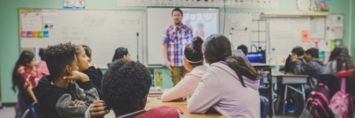 Students sit in a high school classroom. 