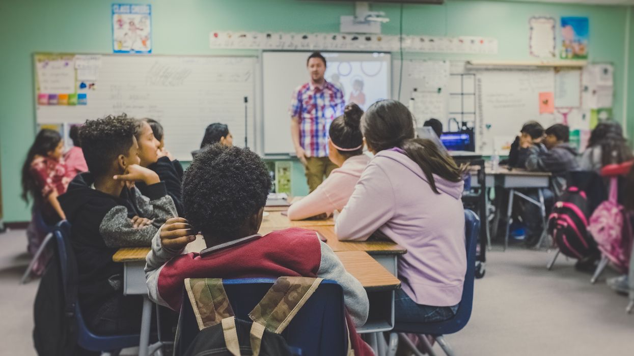 Students sit in a high school classroom.