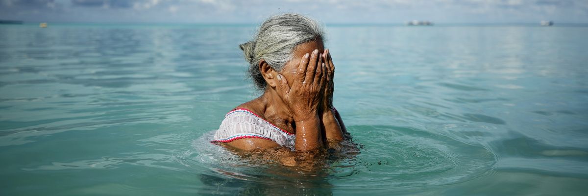 Suega Apelu stands in a lagoon on November 28, 2019 in Funafuti, Tuvalu