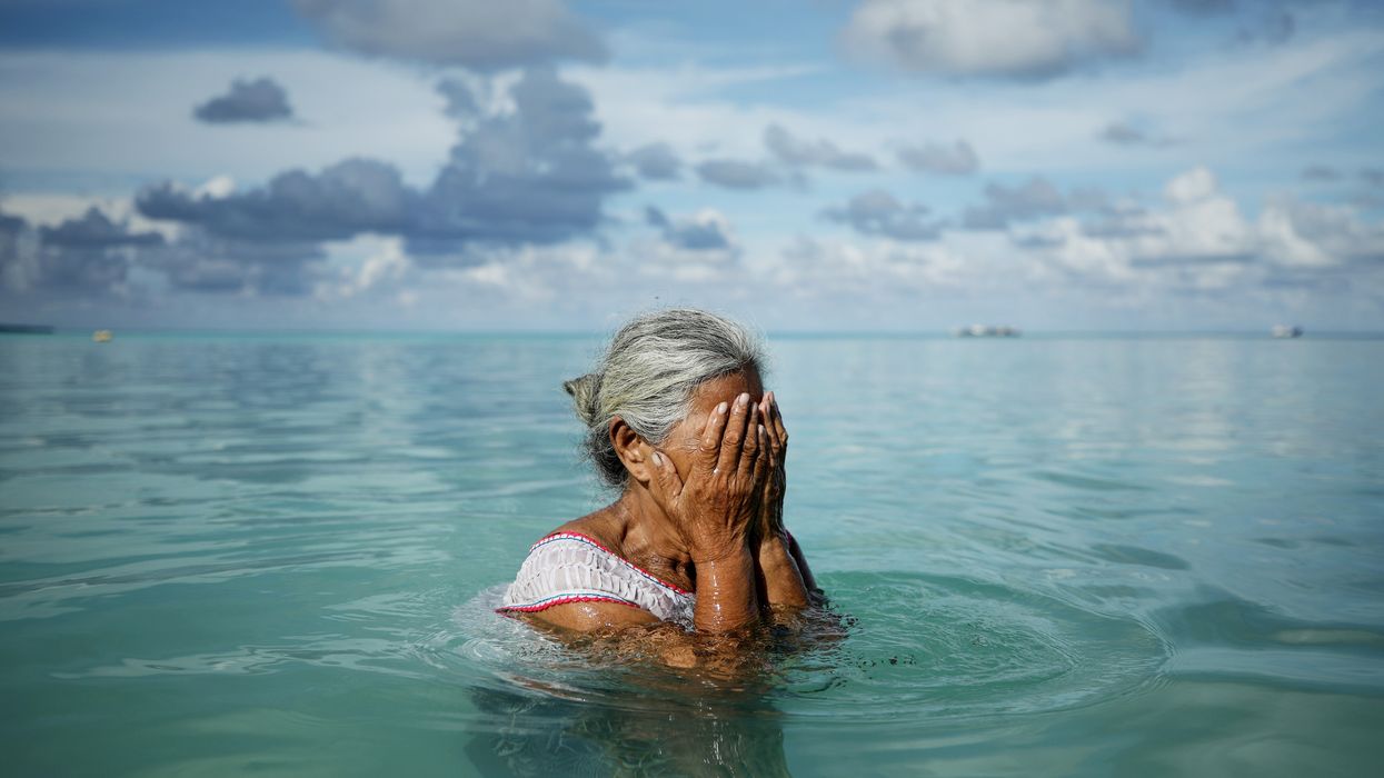 Suega Apelu stands in a lagoon on November 28, 2019 in Funafuti, Tuvalu