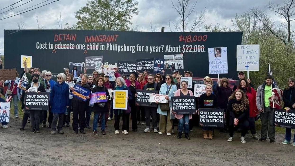 Summer Lee and supporters stand with signs opposing Moshannon ICE facility.