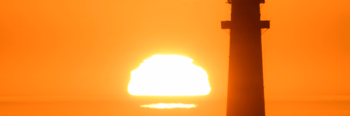 Sun sets behind the Pigeon Point Lighthouse in California
