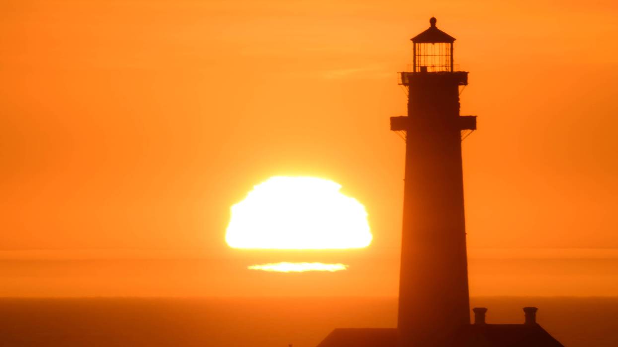Sun sets behind the Pigeon Point Lighthouse in California