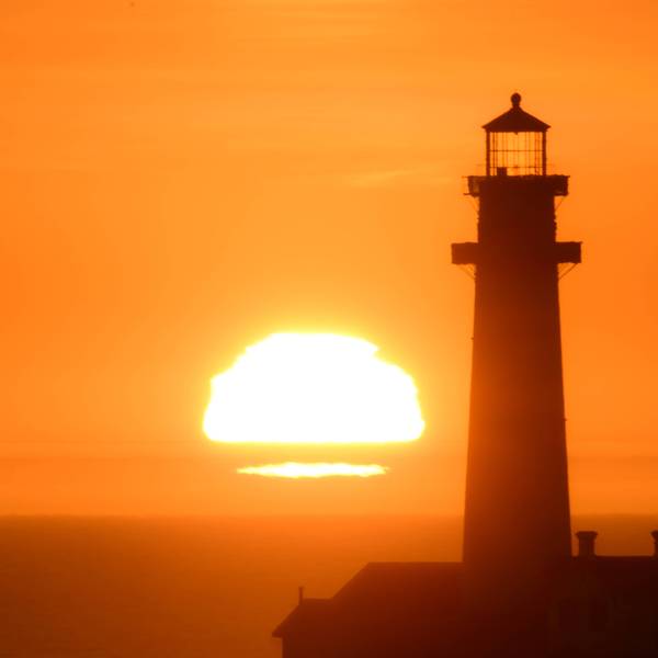 Sun sets behind the Pigeon Point Lighthouse in California