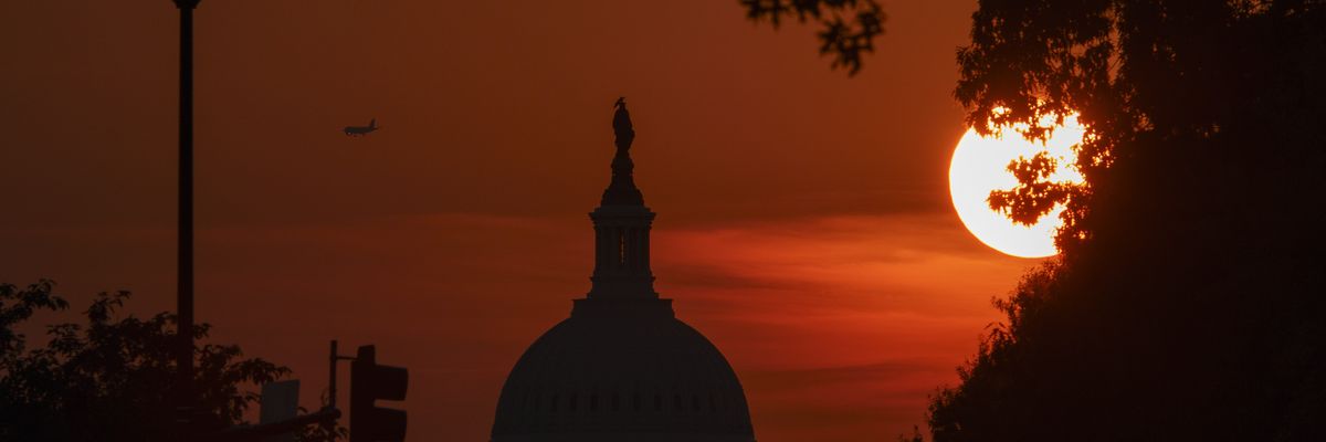 Sun sets behind U.S. Capitol Building.