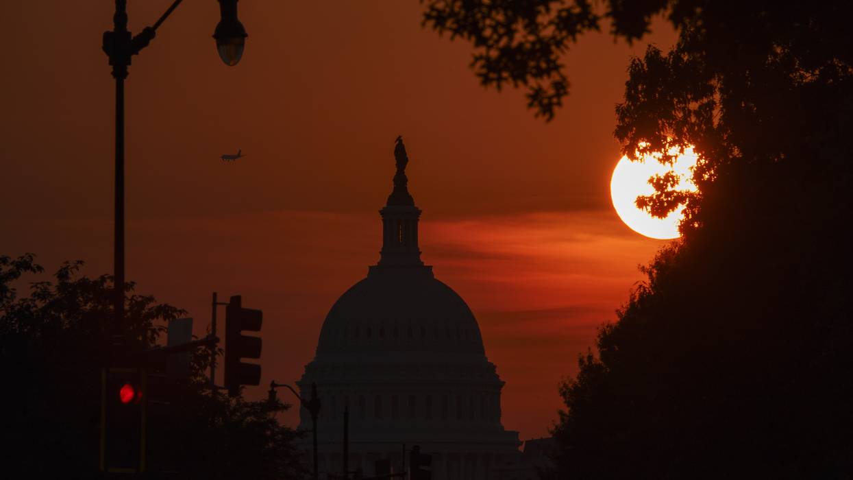 Sun sets behind U.S. Capitol Building.