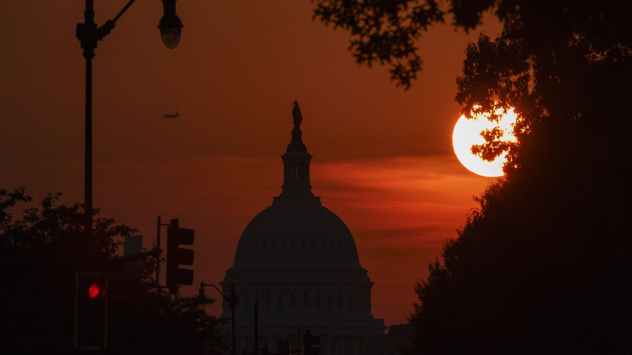 Sun sets behind U.S. Capitol Building.