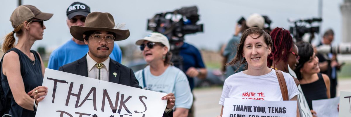 Supporters for Texas Democrats stand outside the Austin Bergstrom International Airport on July 12, 2021 in Austin, Texas. Texas Democrats fled the state to prevent a quorum after protesting SB7, a voting protection bill that Democrats have criticized as being too restrictive.