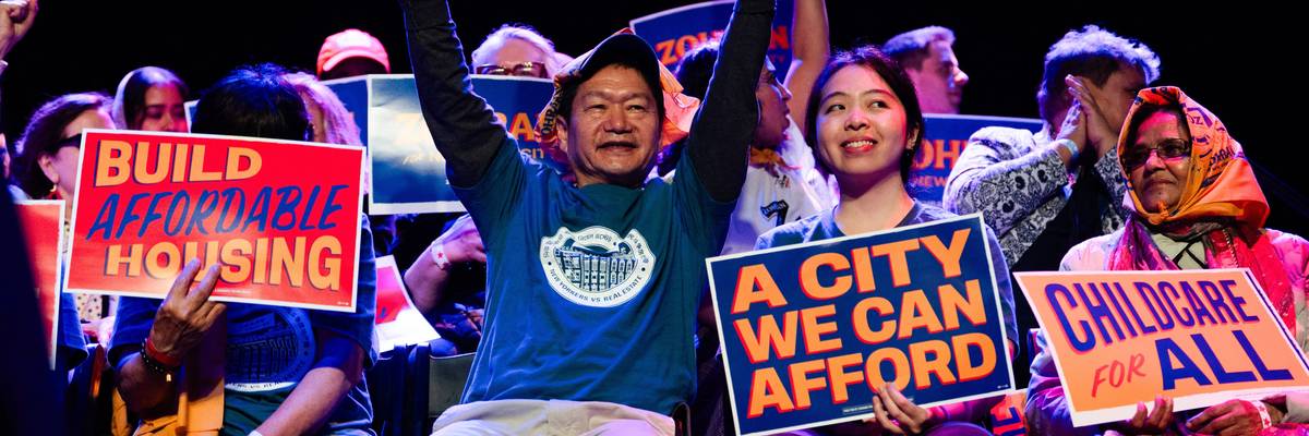 Supporters hold campaign signs and chant slogans during a rally for Zohran Mamdani
