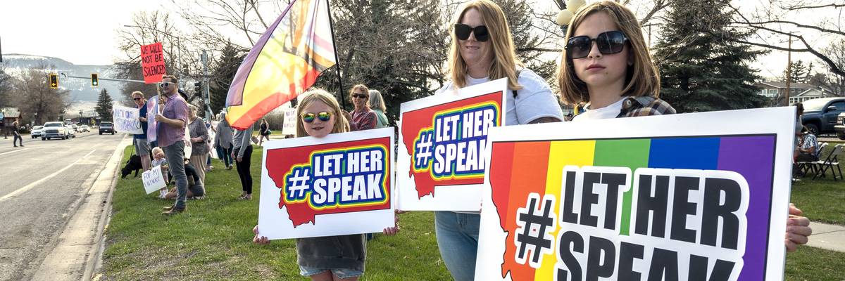 Supporters hold signs near a rally in support of transgender lawmaker Zooey Zephyr
