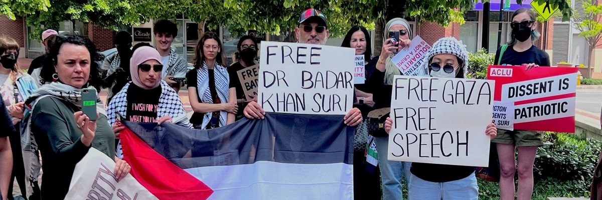 supporters hold signs that say "Free Dr. Badar Khan Suri"