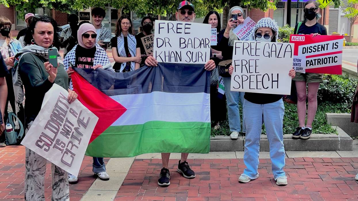 supporters hold signs that say "Free Dr. Badar Khan Suri"