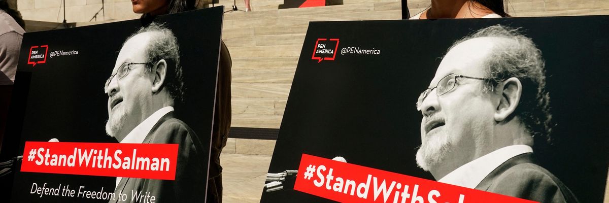 Supporters holding posters of author Salman Rushdie