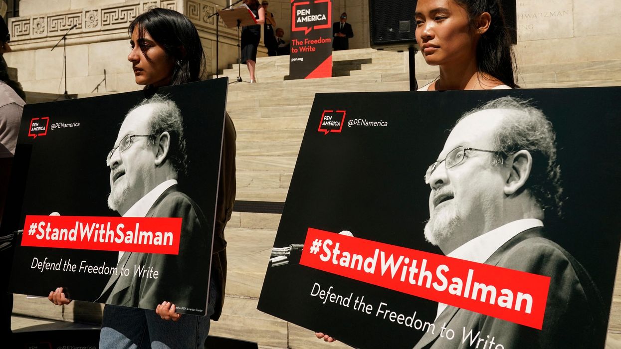 Supporters holding posters of author Salman Rushdie