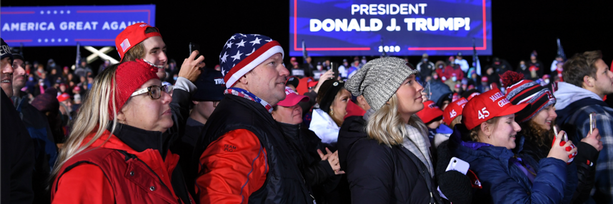 Supporters listen to US President Donald Trump speak during a campaign rally at Waukesha County Airport in Waukesha, Wisconsin
