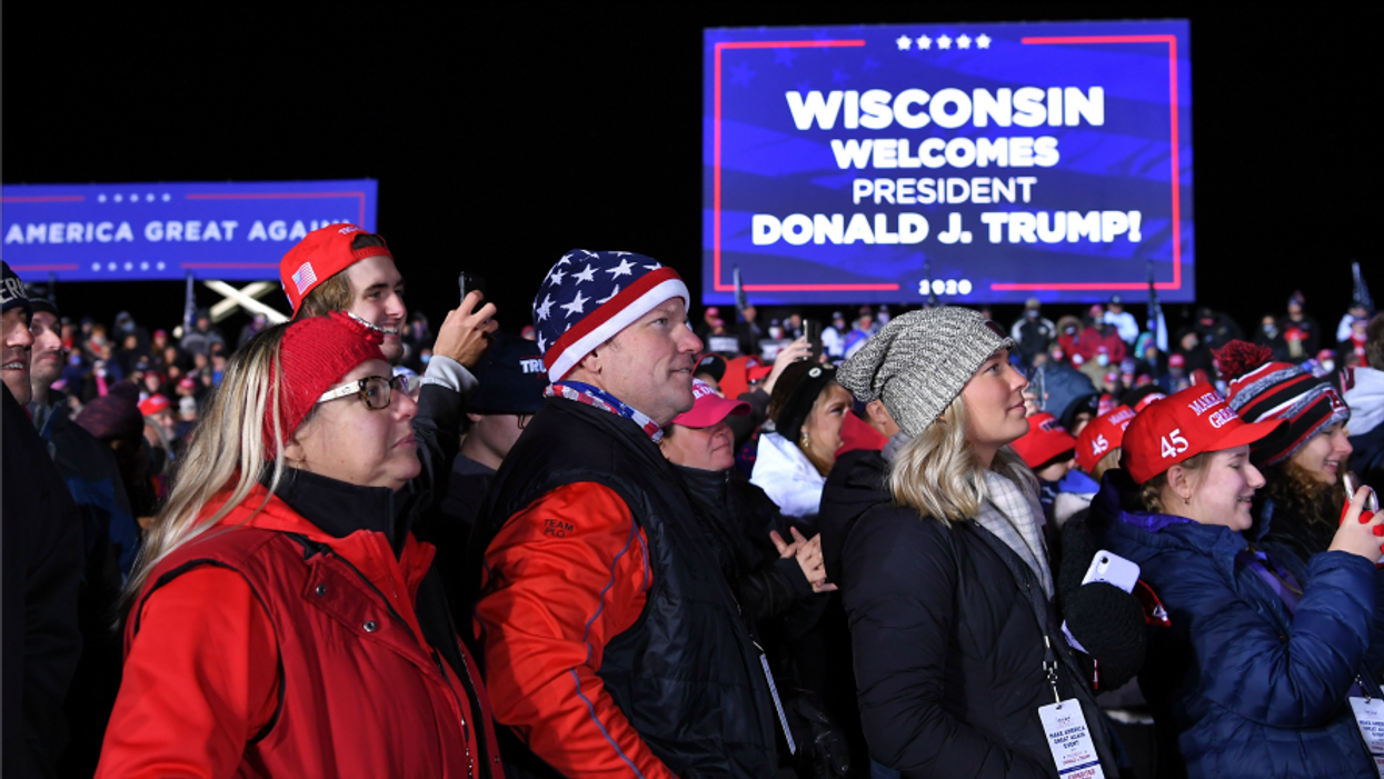 Supporters listen to US President Donald Trump speak during a campaign rally at Waukesha County Airport in Waukesha, Wisconsin