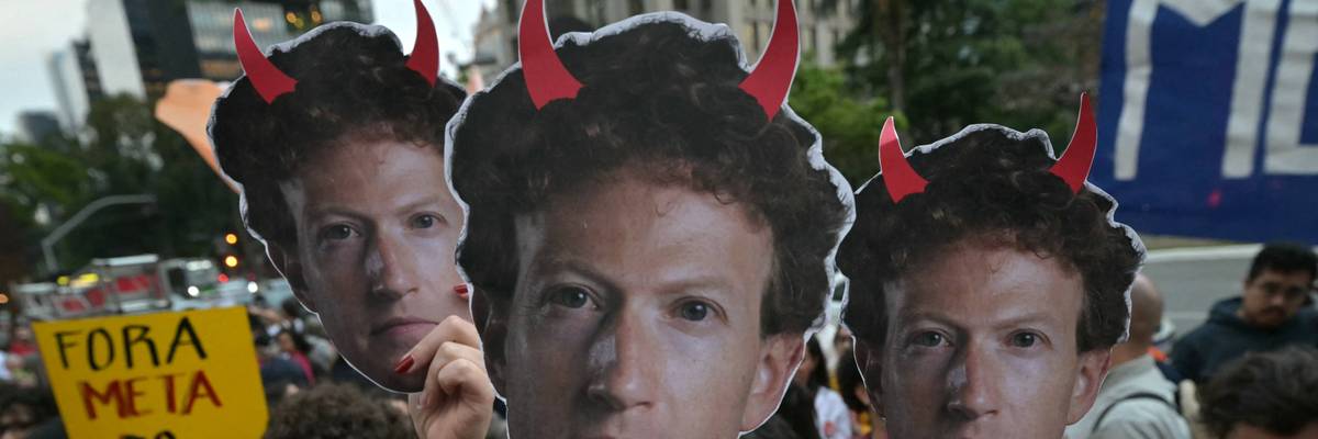 Supporters of Brazilian President Luiz Inácio Lula da Silva hold masks depicting Meta CEO Mark Zuckerberg with red horns