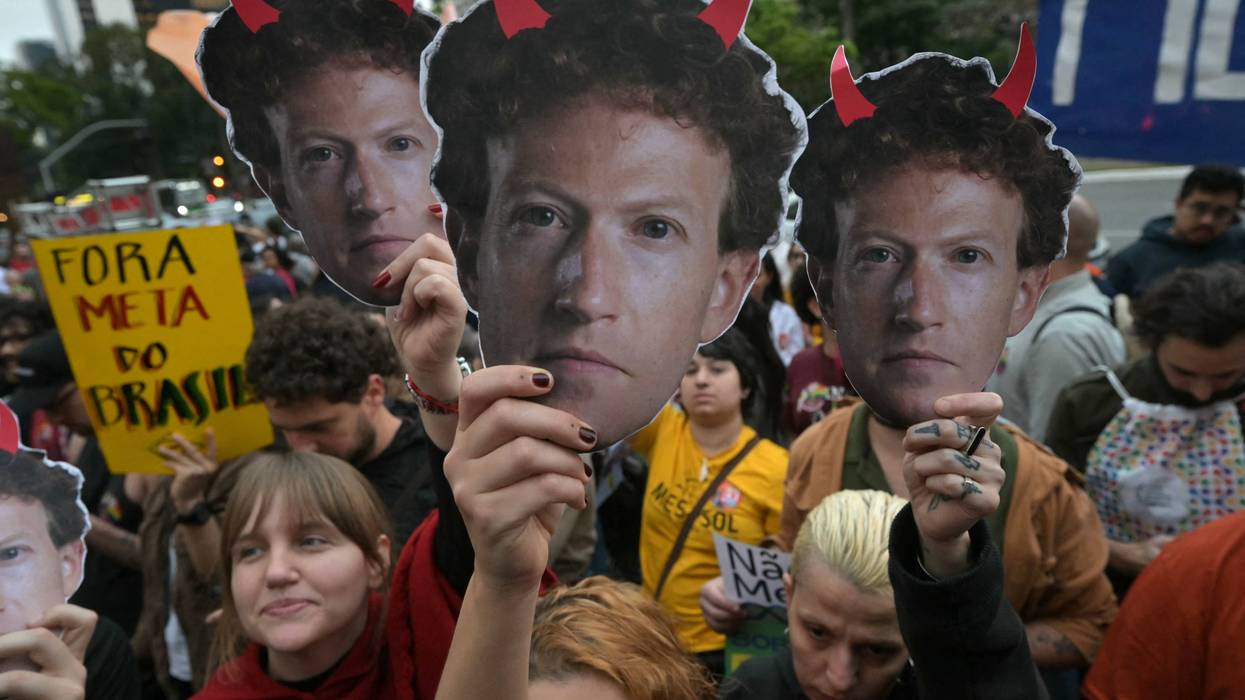 Supporters of Brazilian President Luiz Inácio Lula da Silva hold masks depicting Meta CEO Mark Zuckerberg with red horns