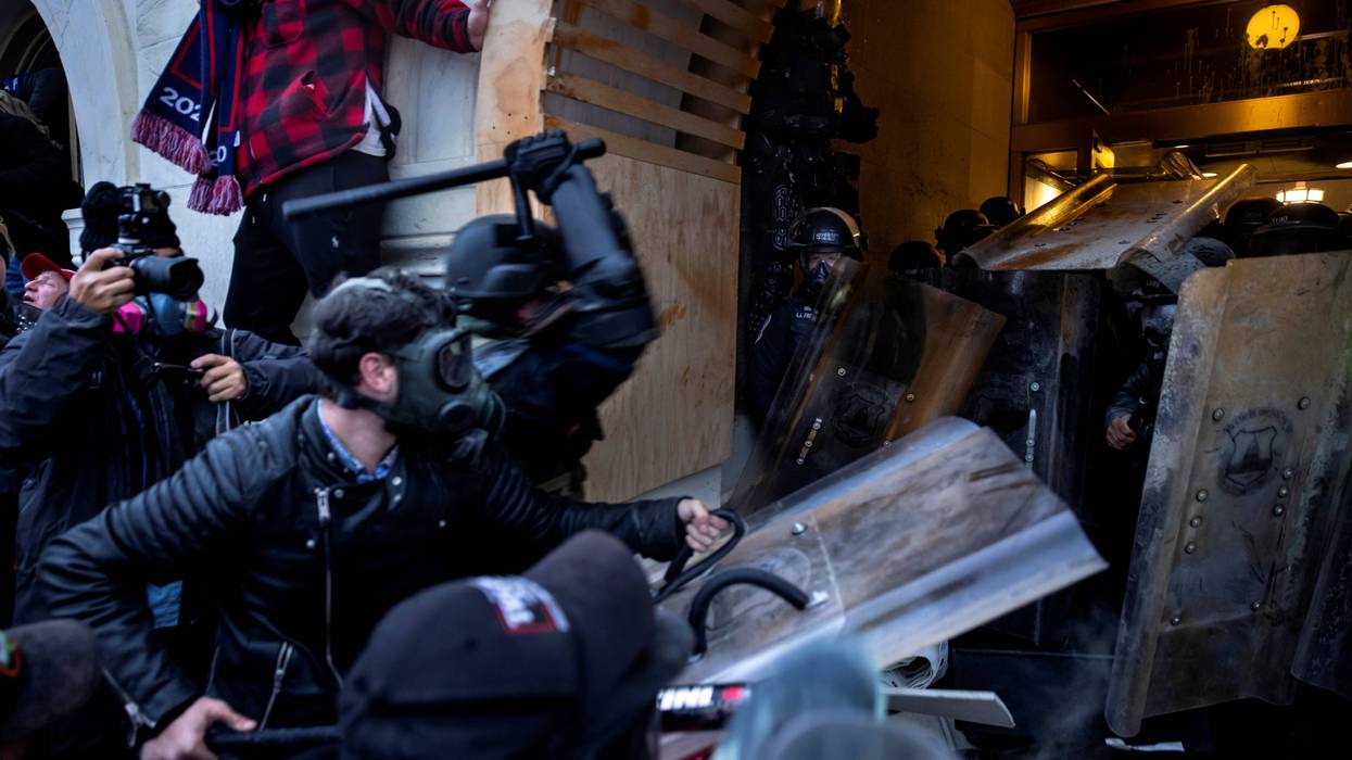 Supporters of Donald Trump attack police with weapons at the US Capitol on January 6, 2021
