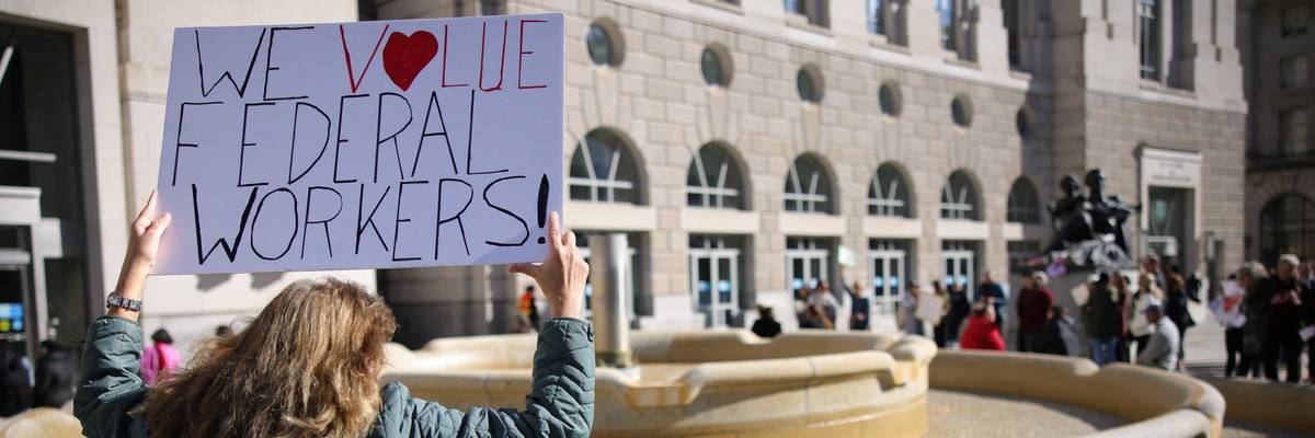Supporters of terminated federal workers gather outside of the offices of the U.S. Agency for International Development