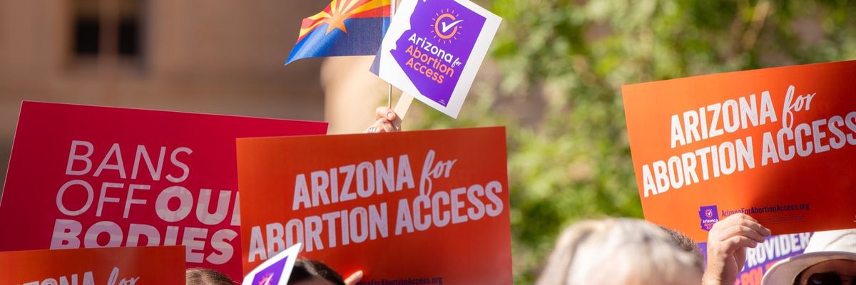 supporters of the ballot measure hold signs