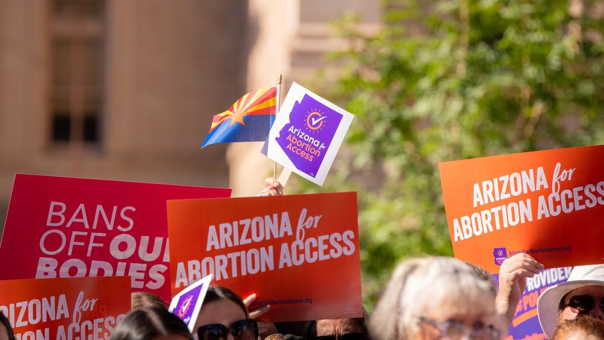 supporters of the ballot measure hold signs