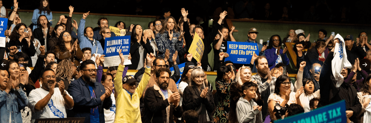 supporters of the California Billionaire Tax applaud in an auditorium