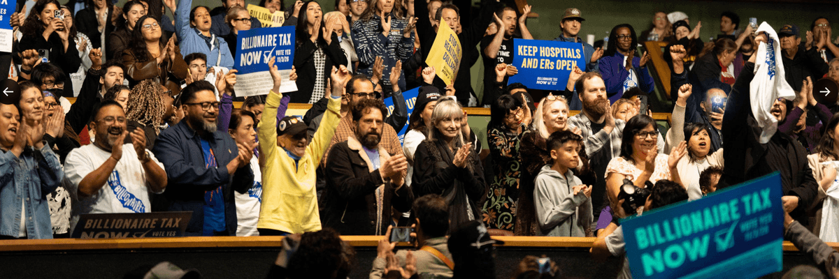 supporters of the California Billionaire Tax applaud in an auditorium