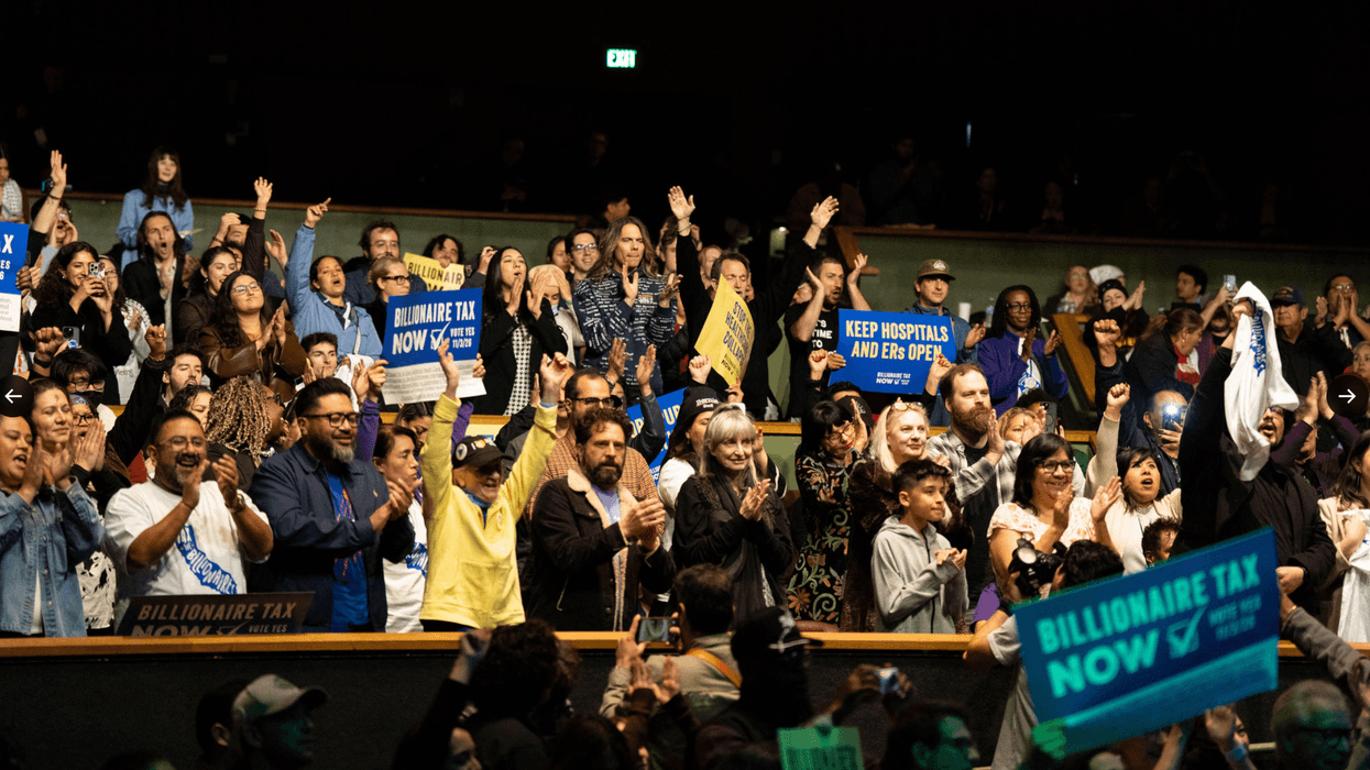 supporters of the California Billionaire Tax applaud in an auditorium