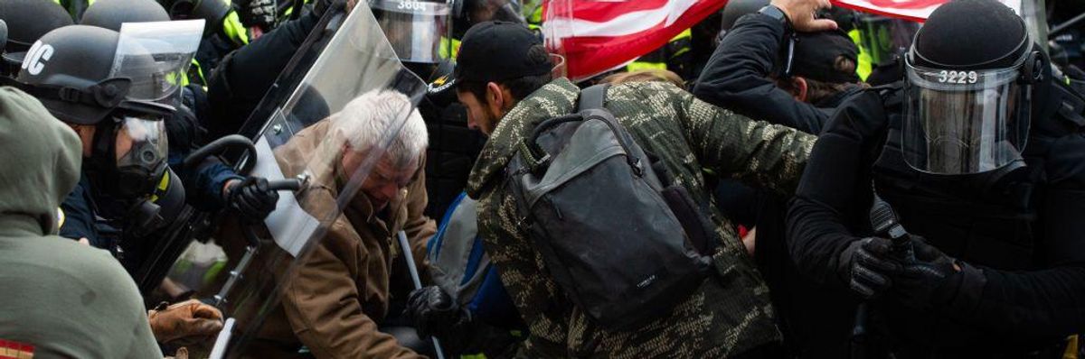 Supporters of U.S. President Donald Trump fight with riot police outside the U.S. Capitol on January 6, 2021 in Washington, D.C.