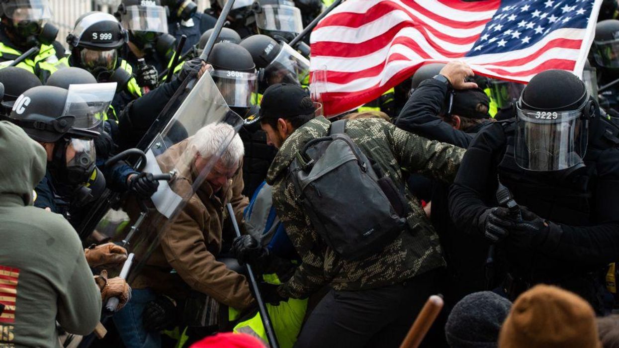 Supporters of U.S. President Donald Trump fight with riot police outside the U.S. Capitol on January 6, 2021 in Washington, D.C.