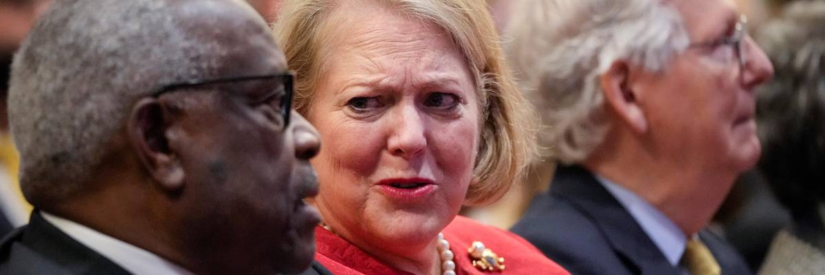 Supreme Court Justice Clarence Thomas sits with his wife Virginia Thomas