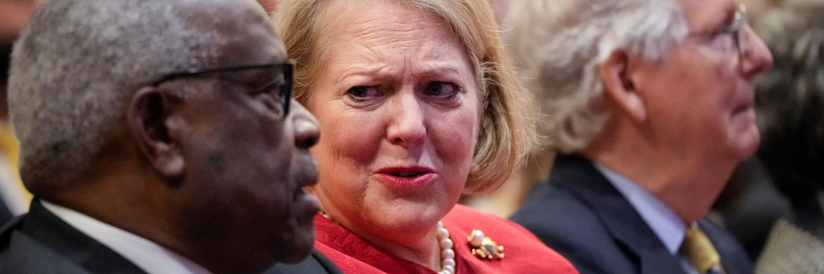 Supreme Court Justice Clarence Thomas sits with his wife Virginia Thomas