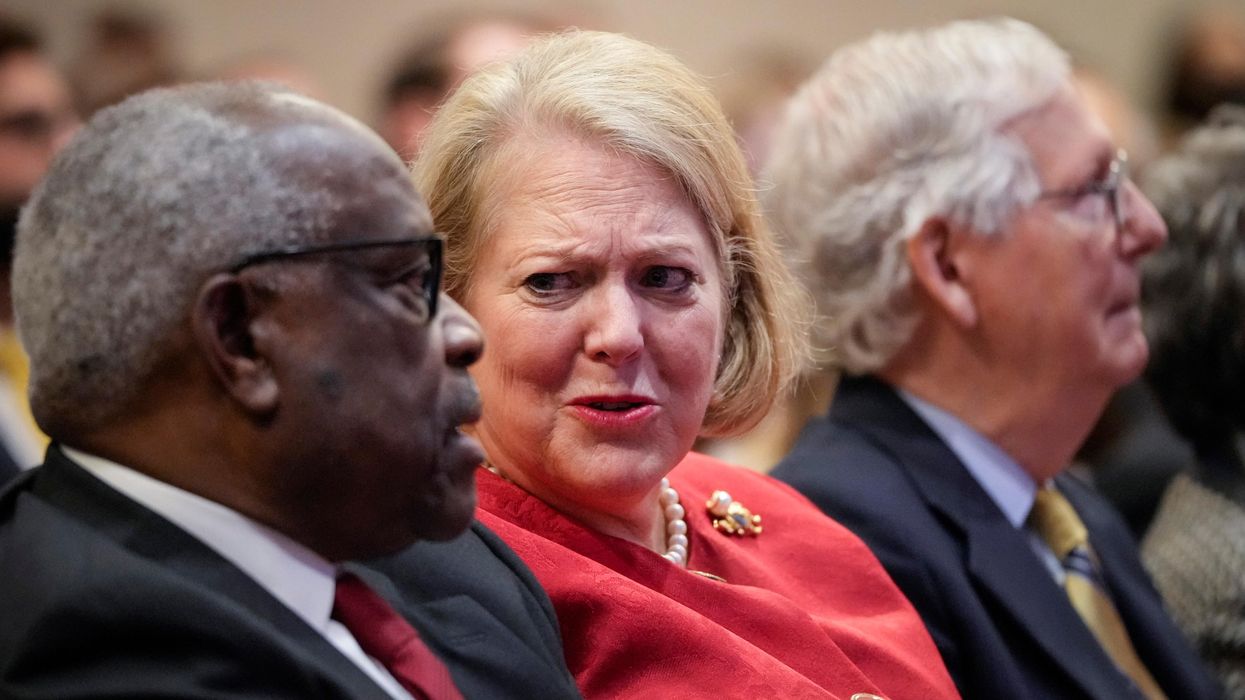 Supreme Court Justice Clarence Thomas sits with his wife Virginia Thomas