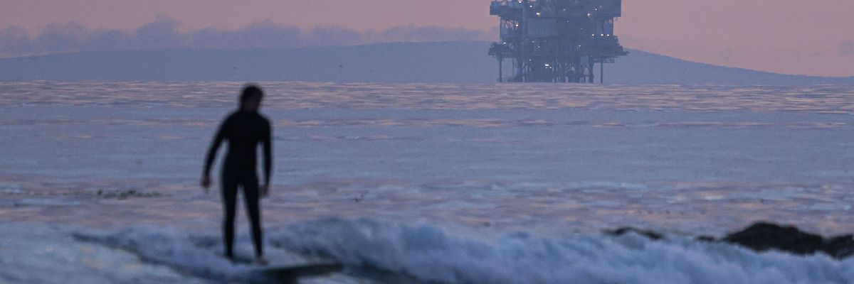 surfer and Santa Barbara oil platform