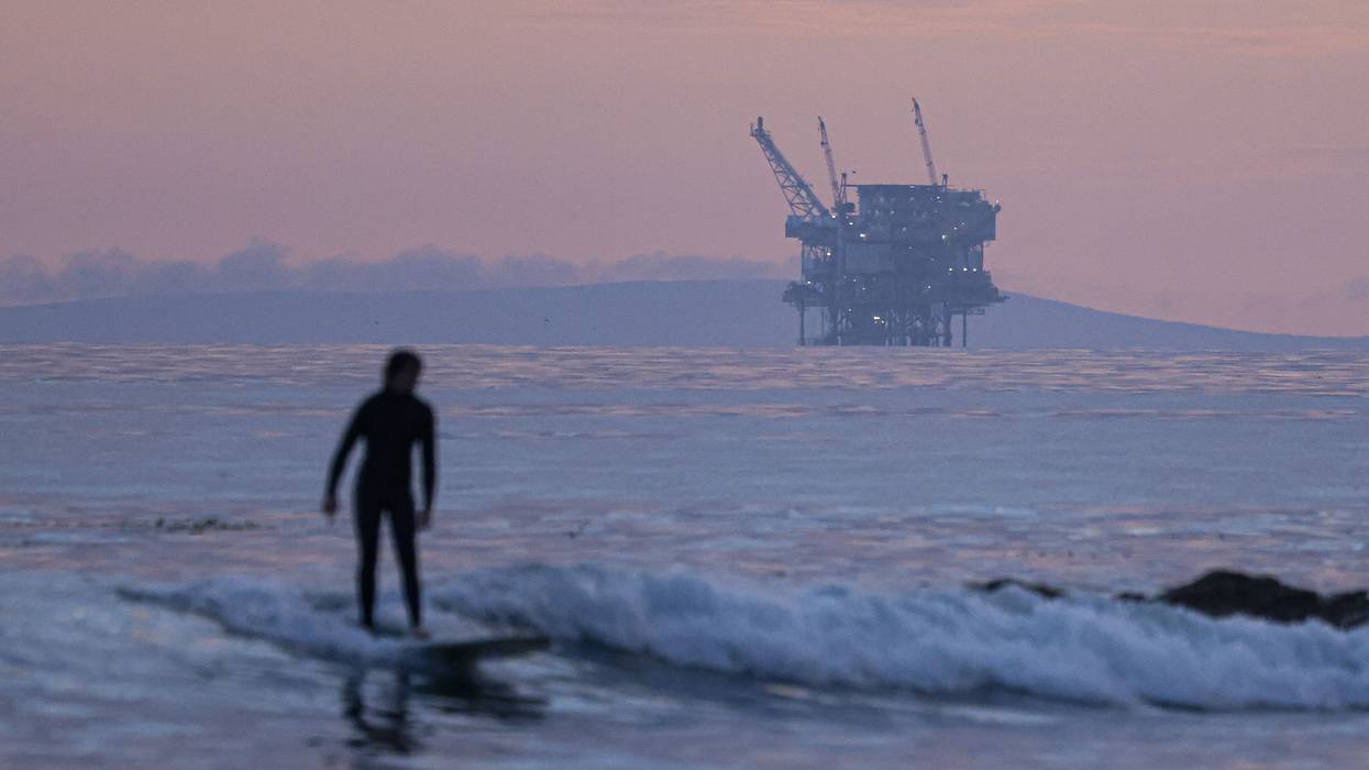 surfer and Santa Barbara oil platform