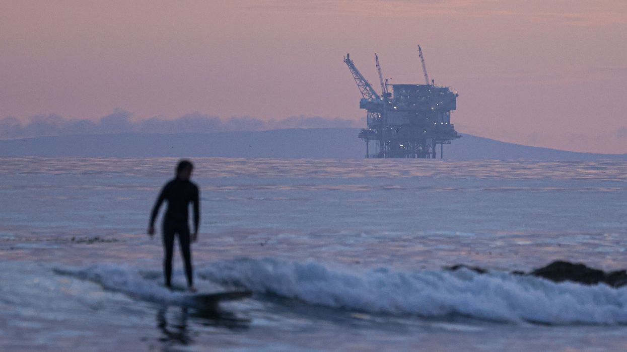 surfer and Santa Barbara oil platform